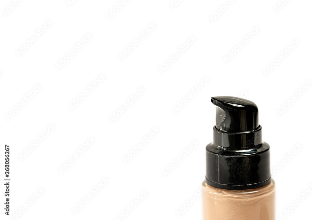 Foundation Bottle with Pump on White Background as Negative Space for Text or Copy Writing. Close Up. Selective Focus. Foundation Bottle with Pump on White Background as Negative Space for Text or Copy Writing. Close Up. Selective Focus.