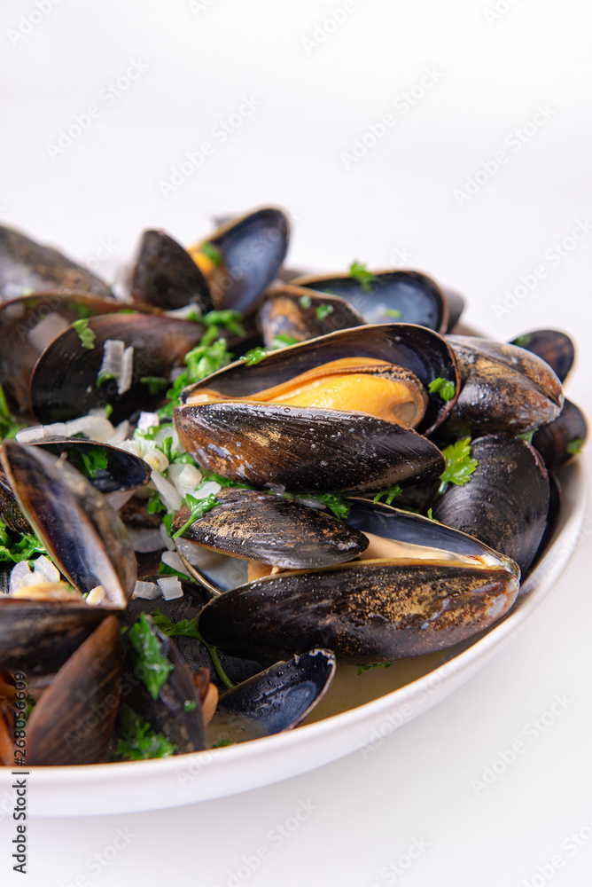 Plate of fresh mussels with onion and parsley mignonette Plate of fresh mussels with onion and parsley mignonette