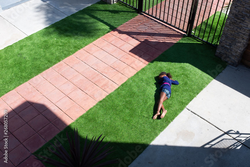 young girl rolling in the grass