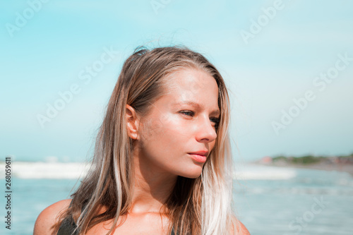 Portrait of beautiful woman in summer on tropical beach closed to ocean. Vacation concept.