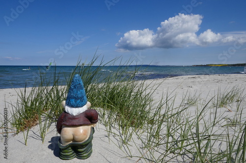 Holidays by the sea ... Dunes, white sandy beach and a little garden gnome with bare bottom (not copyrighted) on the Baltic Sea, on Sehlendorfer beach in Schleswig-Holstein, Germany, Europe photo