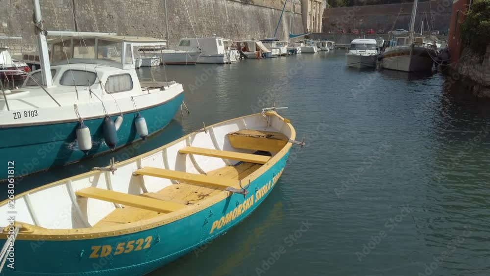 Small boats moored up next to the Ancient Old Town walls and City Gates of Zadar Small boats moored up next to the Ancient Old Town walls and City Gates of Zadar