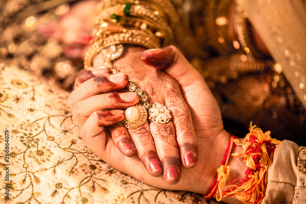 Indian couple holding each other hands during marriage ceremony symbolizing love, promise and togetherness, wedding background. Indian couple holding each other hands during marriage ceremony symbolizing love, promise and togetherness, wedding background.