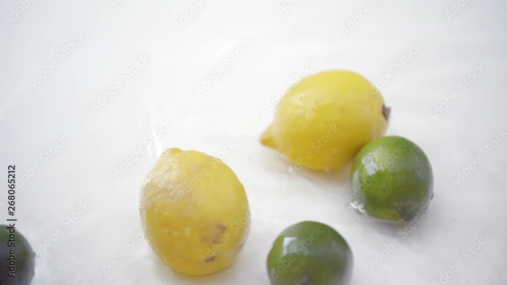 SLOMO of Citrus in Water on White Backdrop SLOMO of Citrus in Water on White Backdrop