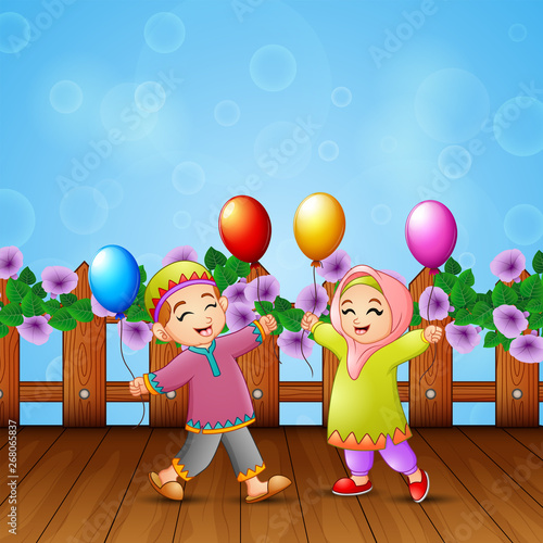 Happy muslim kids holding balloons