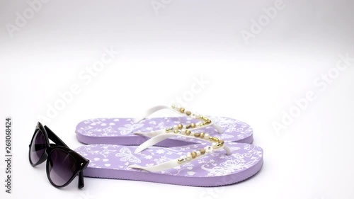 Wallpaper Mural Purple slippers and sunglasses and sea shell on white background - Stop motion  Torontodigital.ca