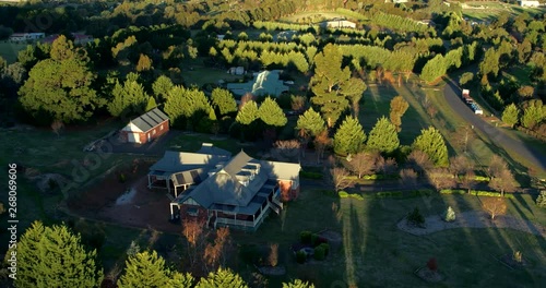 Part 1 of 2 of cinematic aerial capture of country rural properties in lush picturesque landscape during late afternoon light. File 1 of 2 - can be joined. photo