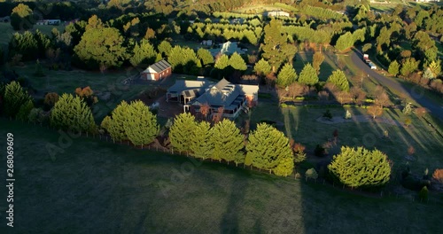 Part 2 of 2 of cinematic aerial capture of country rural properties in lush picturesque landscape during late afternoon light. File 2 of 2 - can be joined. photo
