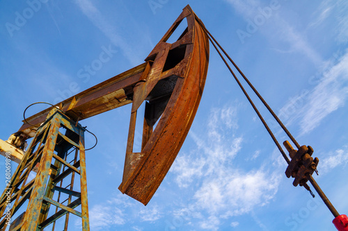 Oil and gas industry. Work of oil pump jack on a oil field in desert