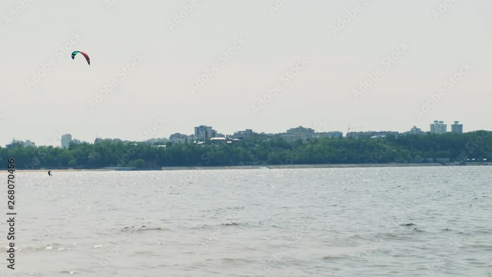 People on the river in the summer engaged in kitesurfing. Extreme sport People on the river in the summer engaged in kitesurfing. Extreme sport