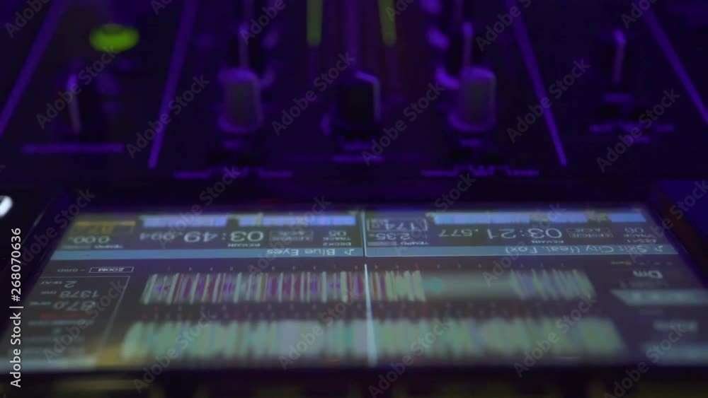 Close up DJ mixer player, laptop screen and sound console for house
