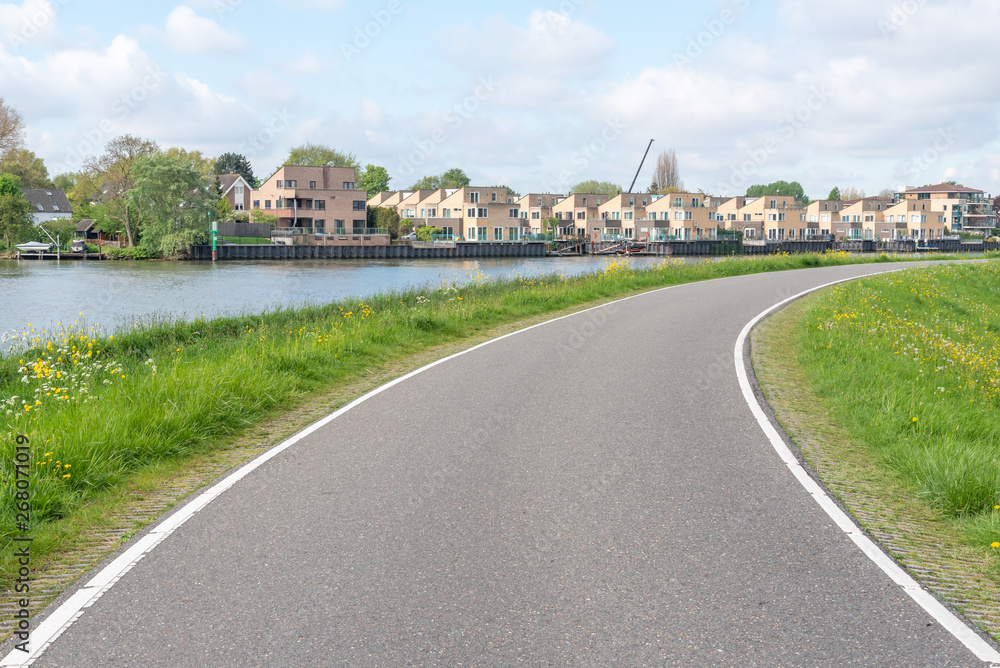 Empty curved road on a dam in the dutch countryside, Capelle Aan Den Ijssel, Netherlands