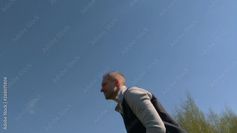 Dad throws his son high up, the child summer sunny day. Slow Motion. father and son have fun outdoor Dad throws his son high up, the child summer sunny day. Slow Motion. father and son have fun outdoor