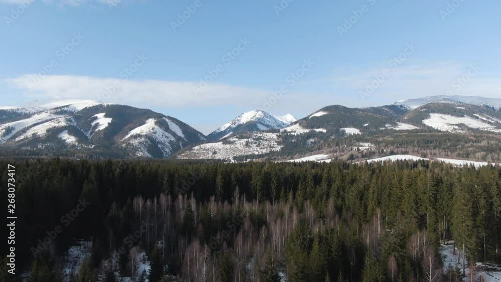 Drone push in, fly over Areal Shot of Green Evergreen Forest, Snowy Mountains, and Blue Sky. Ski holiday in Slovakia in Vysoke Tatry, Central Europe Ski Resort. Drone push in, fly over Areal Shot of Green Evergreen Forest, Snowy Mountains, and Blue Sky. Ski holiday in Slovakia in Vysoke Tatry, Central Europe Ski Resort.
