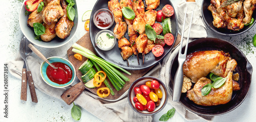 Grilled chicken meat meals on table. Panorama, banner. Top view