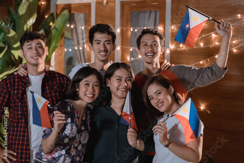 friend celebrating philippines national independence day party at night in the home backyard together photo