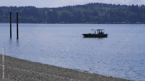 Small, nondescript fishing floating near dock at Camano Island State Park, WA State 30sec/60fps Version 6 photo