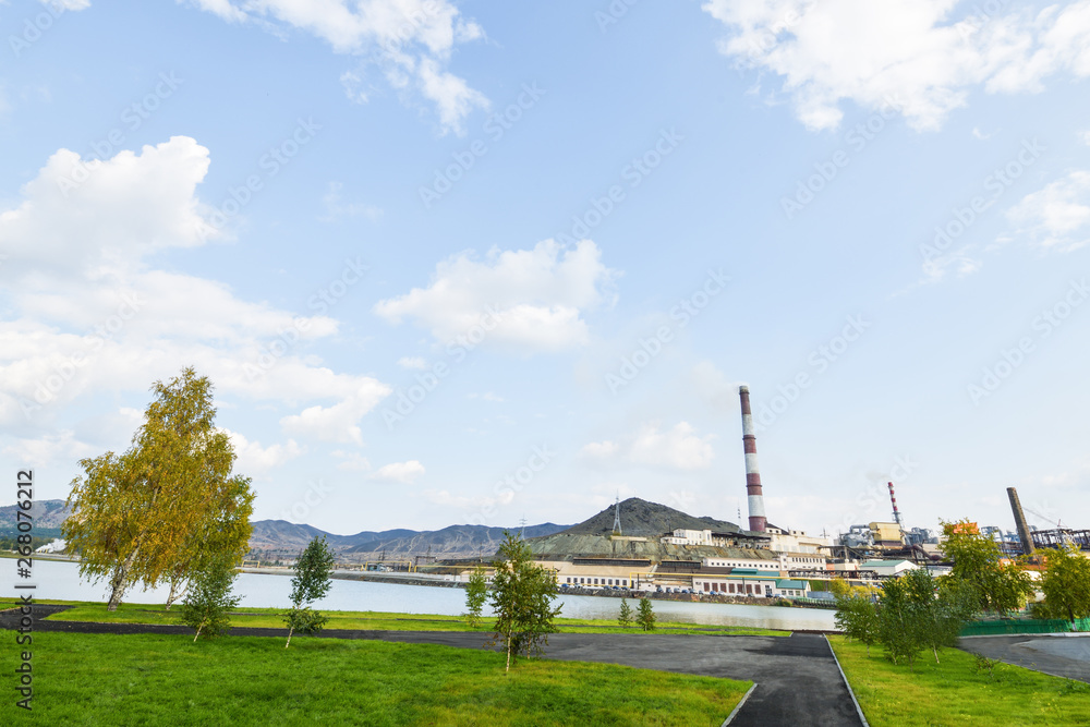 Karabash city in autumn, view of the copper plant and the mountain of black slag. The dirtiest city in the world. Horizontal photography