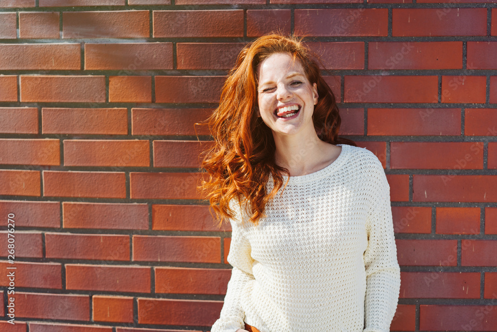 Happy laughing young woman winking Happy laughing young woman winking