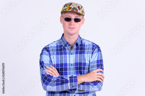 Portrait of young handsome hipster man with arms crossed