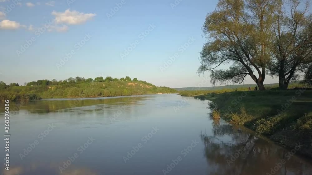 Aerial view of a big river with green banks. Aerial view of a big river with green banks.