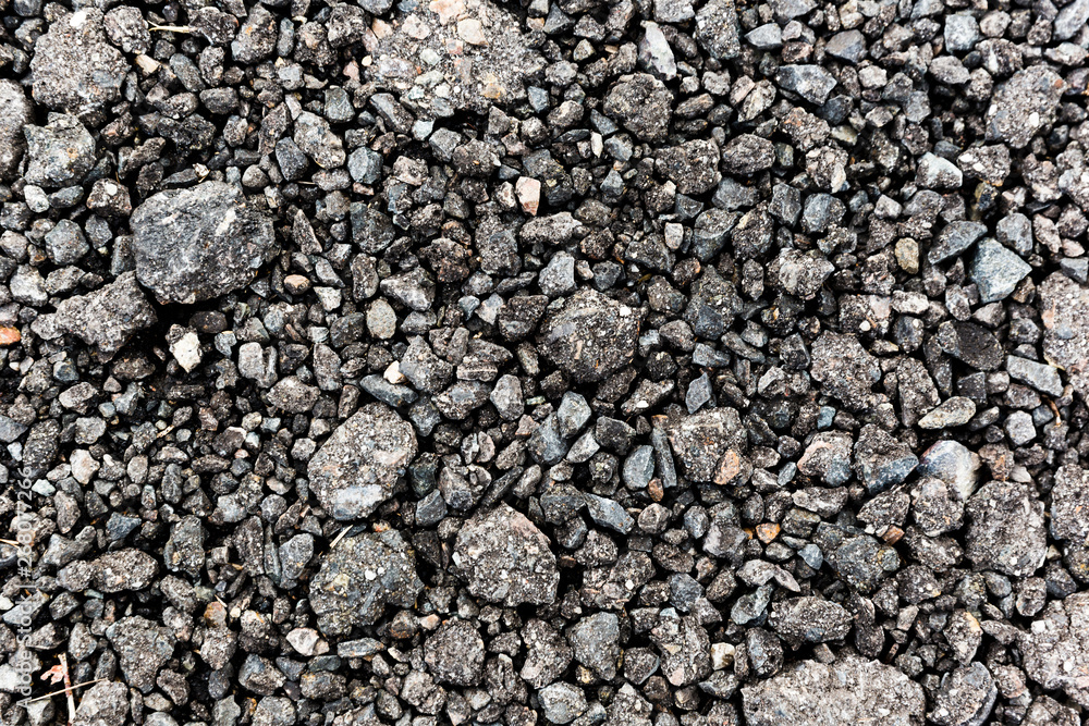 Rough black gravel surface road after rain. Rough black gravel surface road after rain.