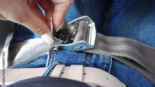 To unfasten the seat belt in the plane