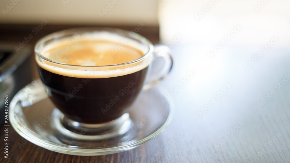 Cup of fresh brewed coffee near the coffee machine Cup of fresh brewed coffee near the coffee machine