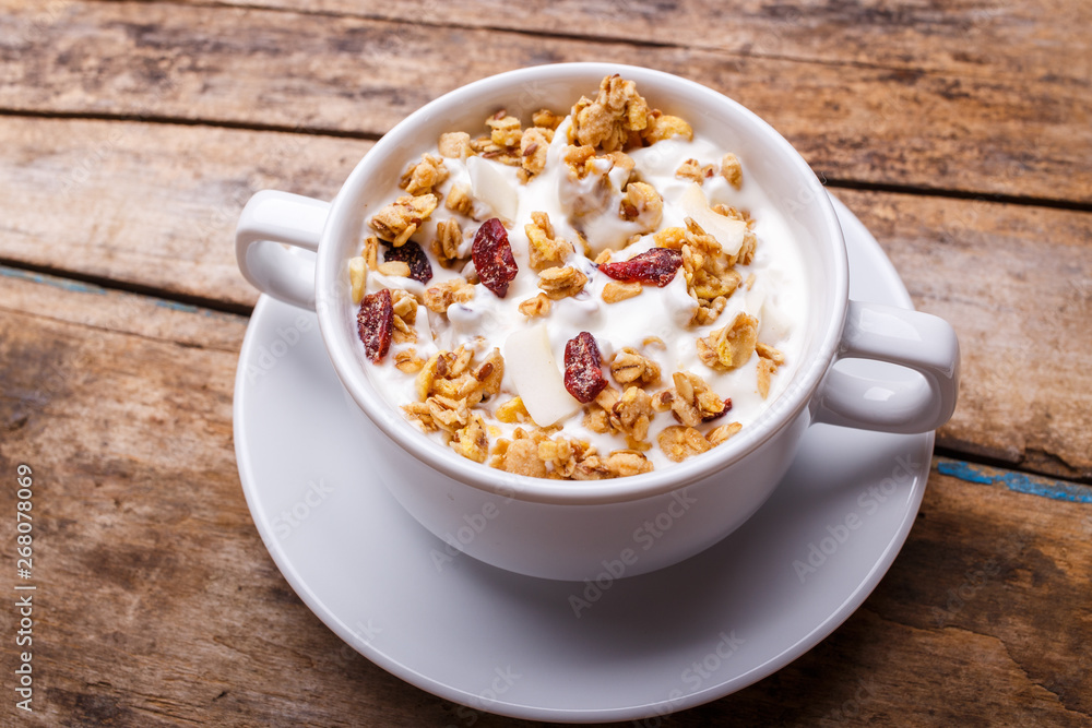 Muesli with yoghurt in white bowl. Healthy fitness breakfast background Muesli with yoghurt in white bowl. Healthy fitness breakfast background