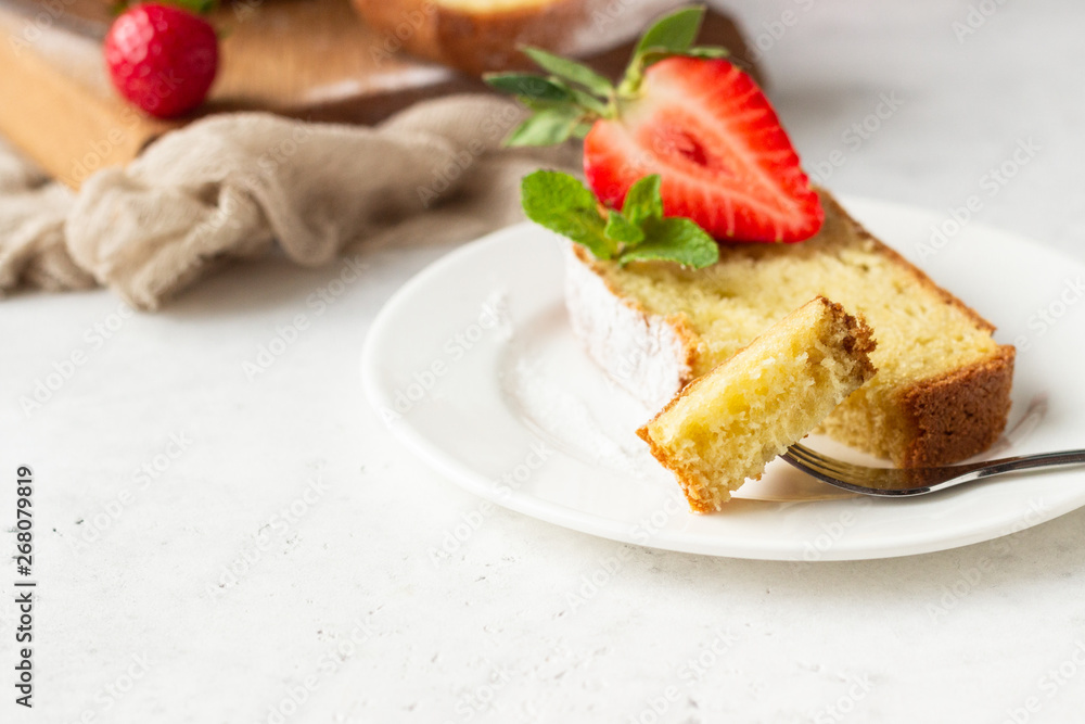 Pound or loaf cake with strawberry and mint on wooden board. Delicious summer dessert. Pound or loaf cake with strawberry and mint on wooden board. Delicious summer dessert.