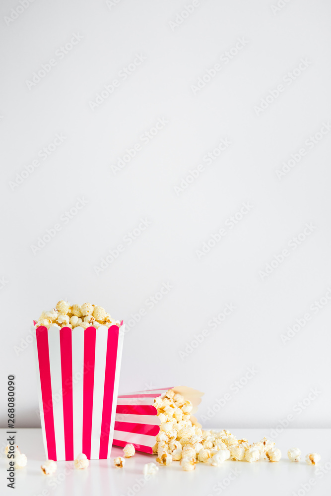 striped boxes with popcorn and copy space over white