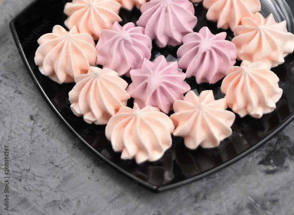 Meringues in plate on stone background. Meringues in plate on stone background.