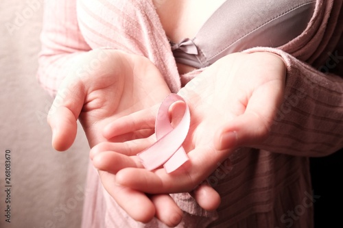 Female holding pink cancer awareness ribbon 