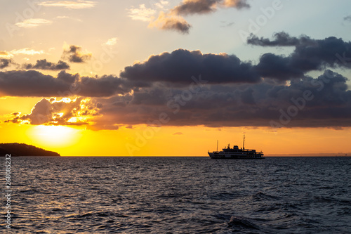 passenger ship that sails in a bright yellow sunset near the Istanbul Islands