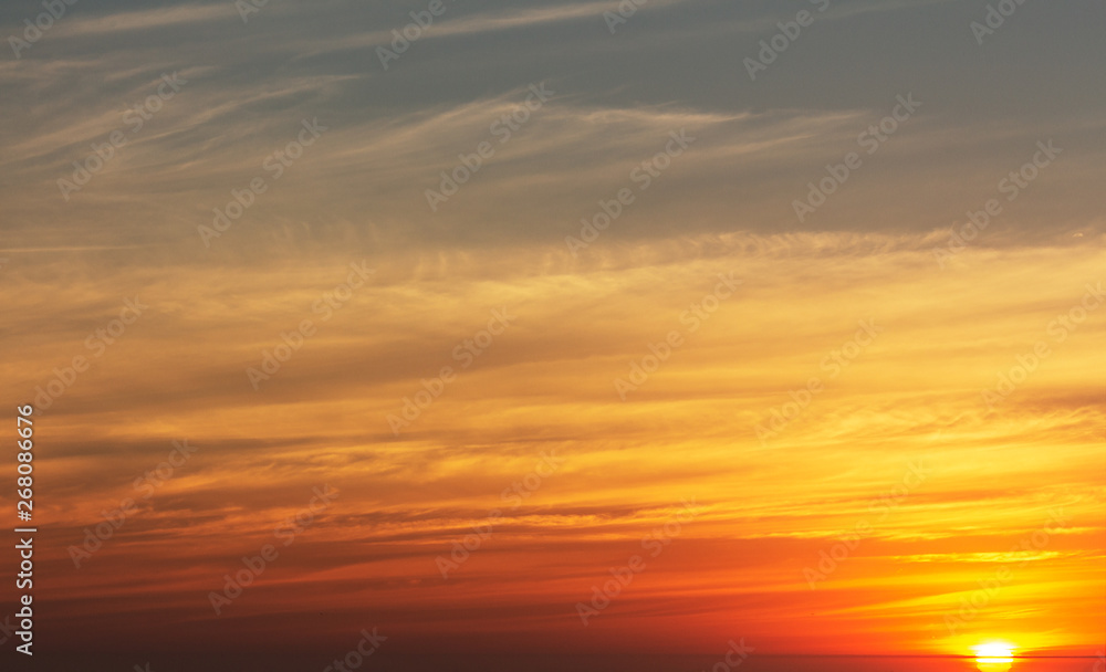 beautiful red sunset and bright sun on the horizon