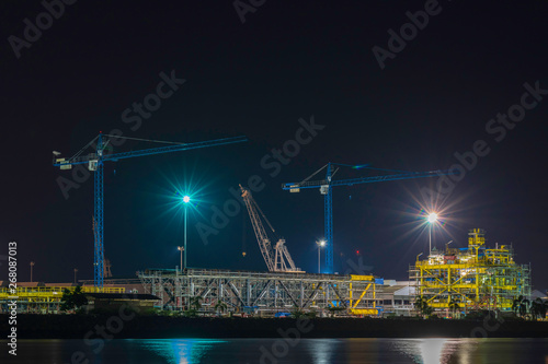 Silhouettes of crane the evening sky. Construction industry.