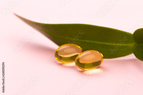 Fish oil in capsules. For health and immunity on pink