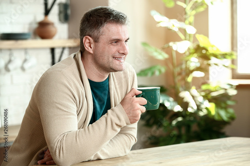Handsome mature man drinkin...