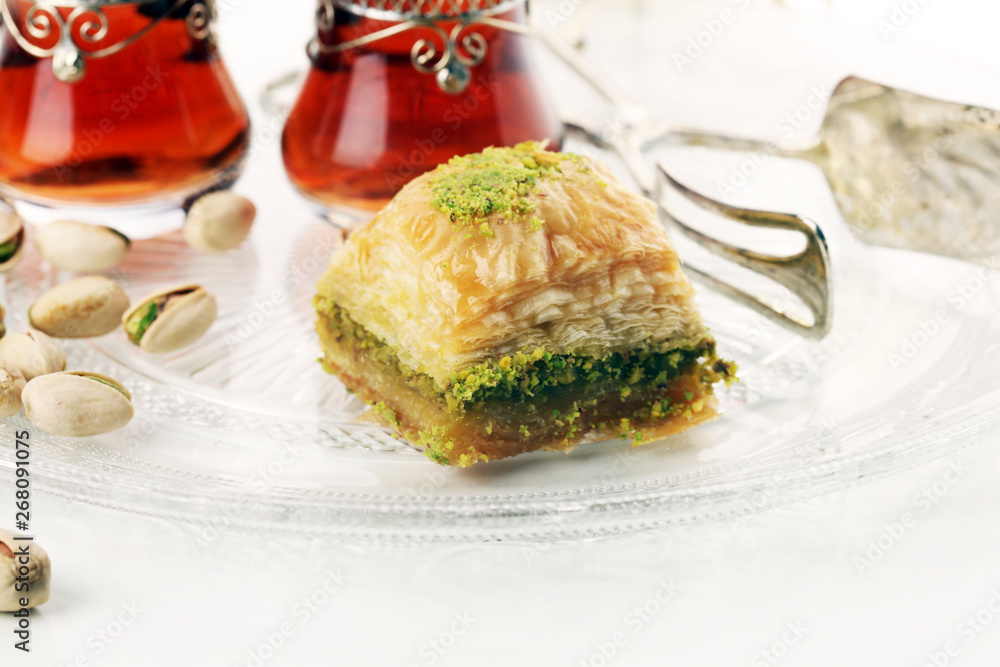 Middle eastern or arabic dishes. Turkish Dessert Baklava with pistachio on dishes Middle eastern or arabic dishes. Turkish Dessert Baklava with pistachio on dishes
