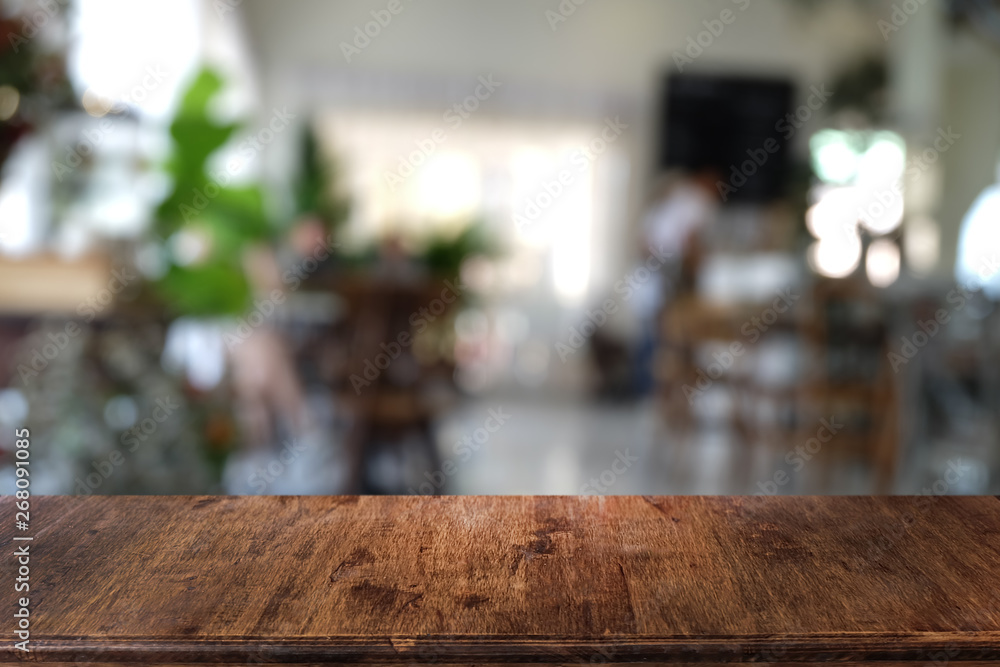 Empty dark wooden table in front of abstract blurred bokeh background of restaurant . can be used for display or montage your products.Mock up for space. Empty dark wooden table in front of abstract blurred bokeh background of restaurant . can be used for display or montage your products.Mock up for space.