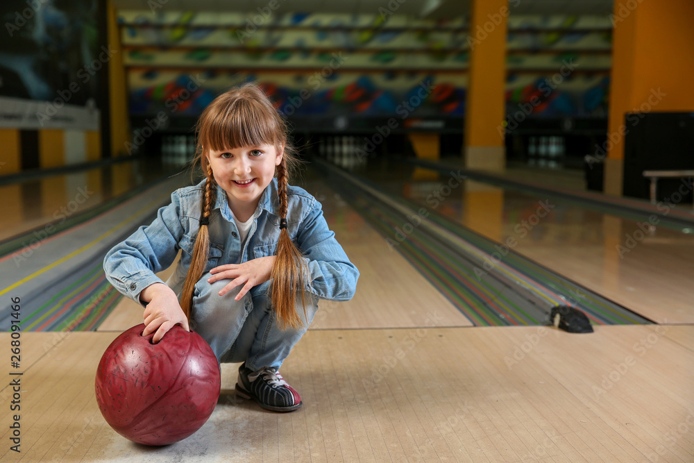 Fototapeta premium Little girl in bowling club
