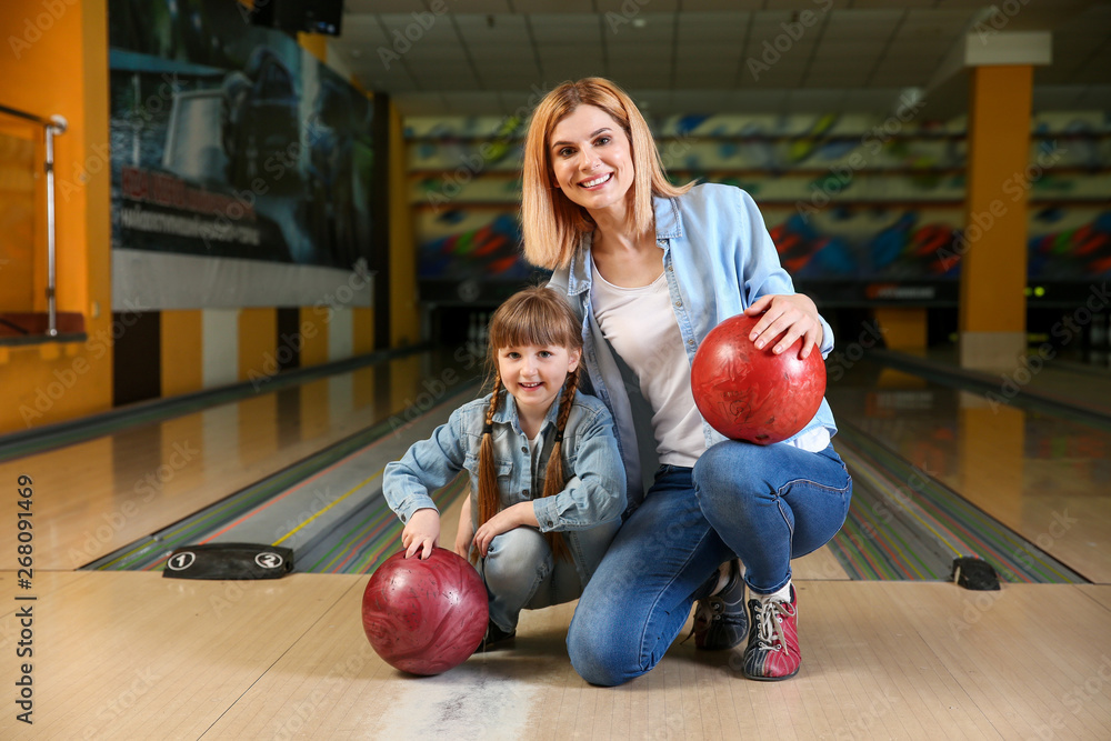Fototapeta premium Woman with little daughter in bowling club