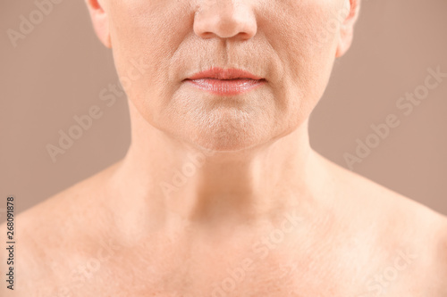 Mature woman on color backg...