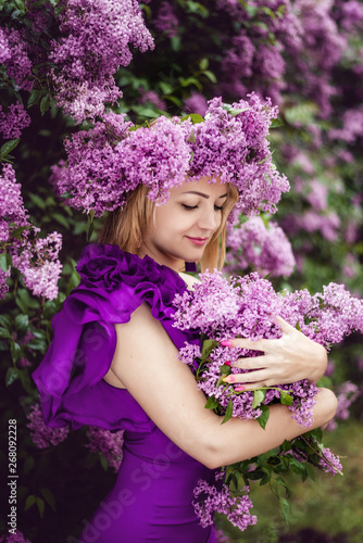 Beautiful girl in lilac ball dress among the flowers in the garden © Ксения Пальчик