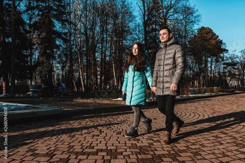 A young couple walks in the City Park of the city on the day of St. Valentine.