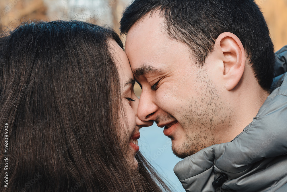 Loving couple kissing outdoor at sunset - Concept about people, love and lifestyle Loving couple kissing outdoor at sunset - Concept about people, love and lifestyle