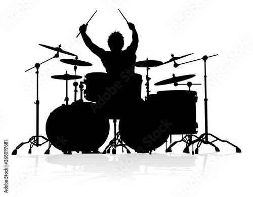 A drummer musician drumming drums in detailed silhouette