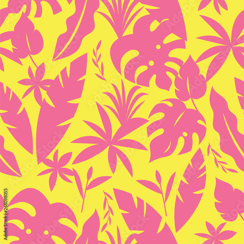 Seamless tropical pattern with palm leaves and green plants in yellow and pink color
