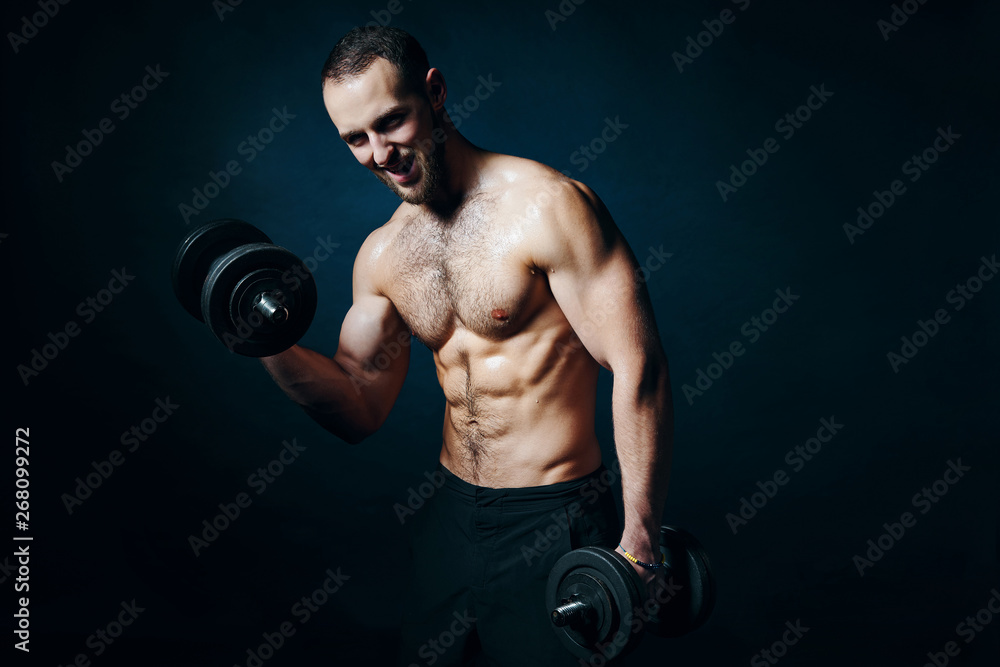 Strong sport sirtless man making weightlifting with dumbbells