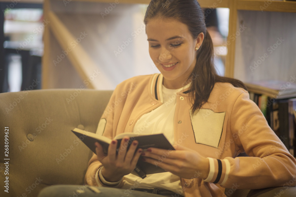 Fototapeta premium Engrossed in the fantasy of her novel.